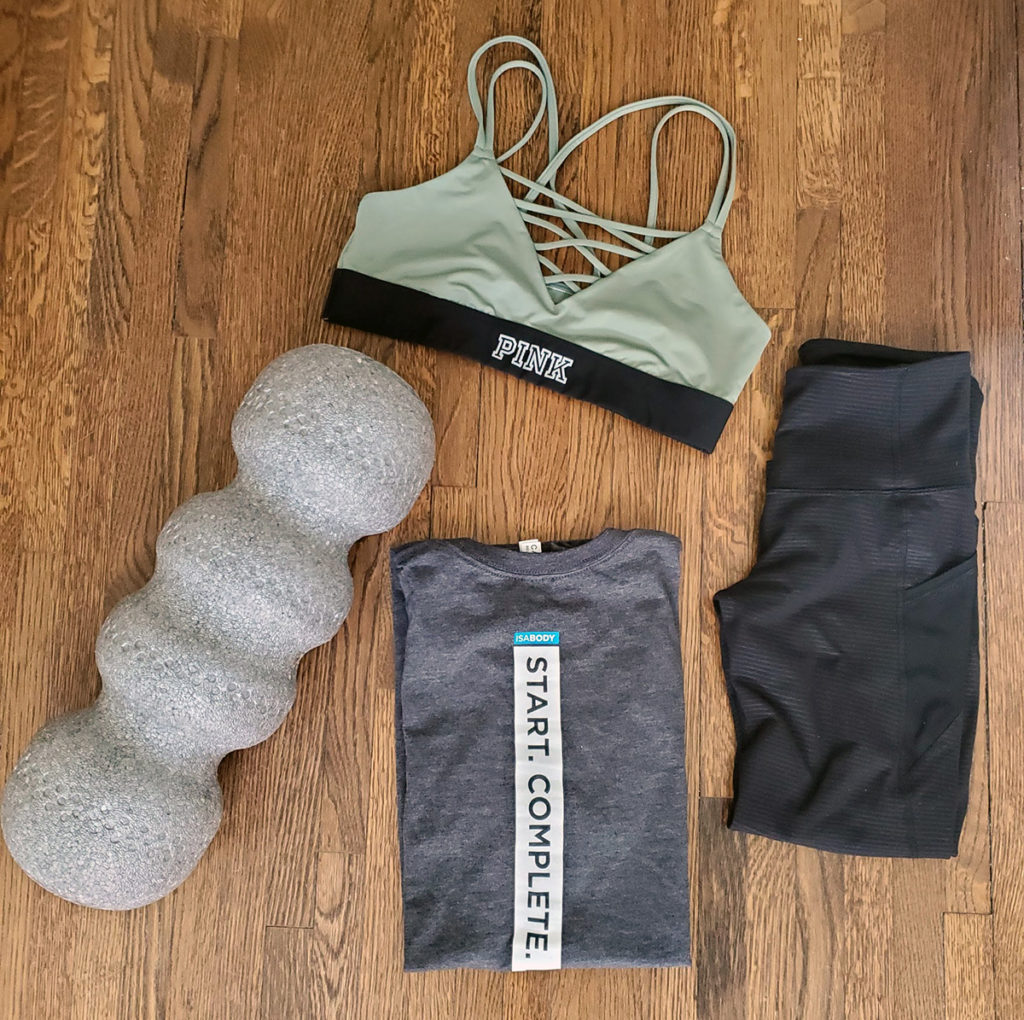 Workout Essentials foam roller, sports bra, t shirt, and leggings